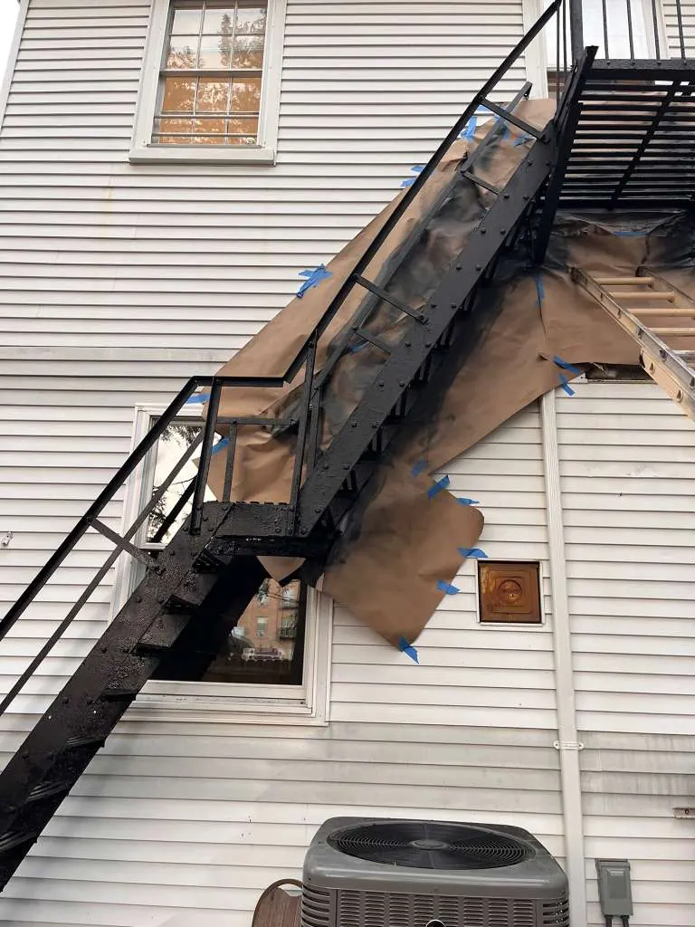 Before exterior stair painting project with masking and surface preparation